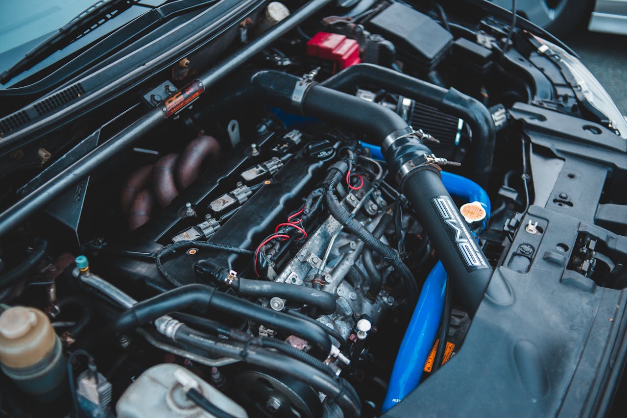Detailed view of a car engine with visible components, highlighting automotive engineering.